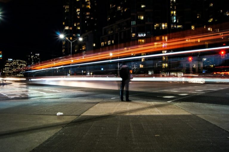 Cars Driving Past Man Quickly